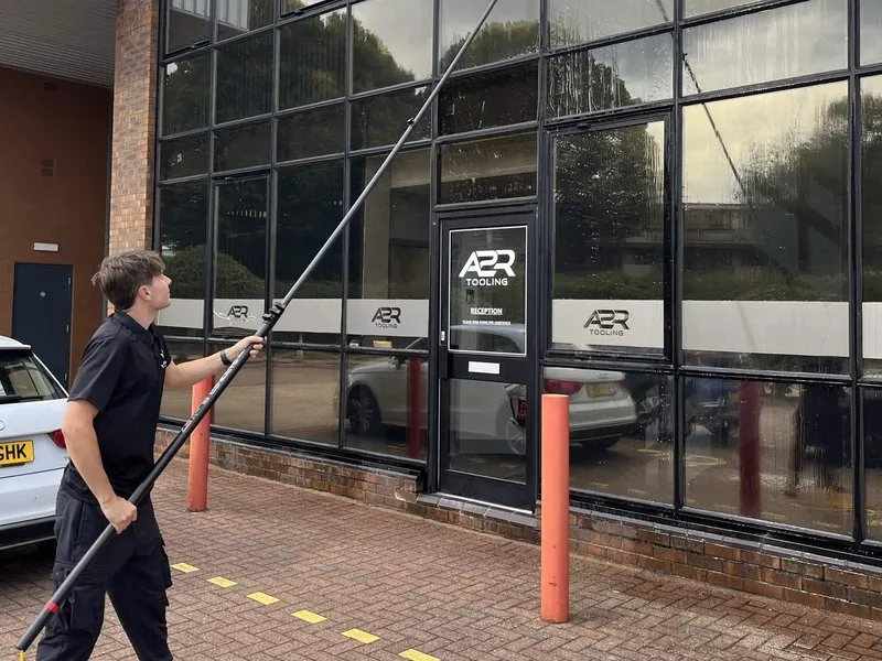Pure water pole cleaning the glass front of an office building